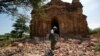 FILE - A photographer walks outside a collapsed pagoda after an earthquake in Bagan, Myanmar, Aug. 25, 2016. 