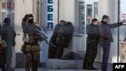 Armed Russian forces arrest Ukrainian army officers during an operation in Simferopol on March 18, 2014. 