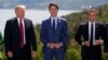 Le président Donald Trump, le premier ministre canadien Justin Trudeau et le président français Emmanuel Macron au moment de la photo de famille lors du Sommet du G-7, le vendredi 8 juin 2018, à Charlevoix, au Canada. (AP Photo / Evan Vucci)