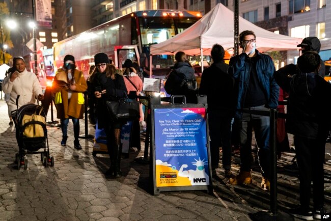 Patients wait to receive a COVID-19 vaccine booster shot at a mobile vaccination station on 59th Street below Central Park, in New York, Dec. 2, 2021.