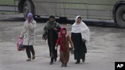 Women walk in Kabul, Afghanistan, on Wednesday, Jan. 4, 2012. The UN says the number of reported violent attacks against Afghan women has more than doubled in a year. 