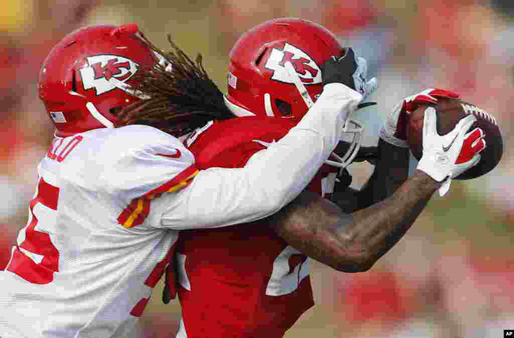 Kansas City Chiefs wide receiver Dexter McCluster (22) makes a catch while covered by defensive back Greg Castillo (45) during NFL football training camp in St. Joseph, Missouri, USA.