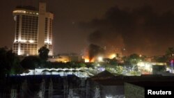 Smoke rises from the site of car bomb attack in Baghdad, May 29, 2015. 