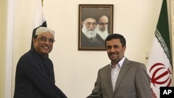 Iranian President Mahmoud Ahmadinejad shakes hands with his Pakistani counterpart Asif Ali Zardari, at the start of their meeting in Tehran, Iran, July 16, 2011