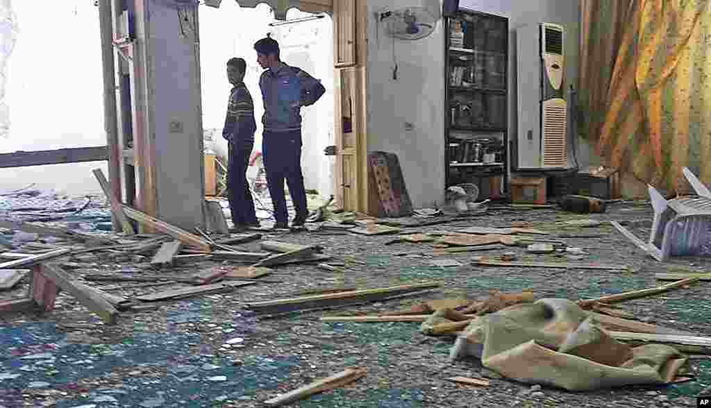 This citizen journalism image shows Syrian boys inside a damaged mosque that was attacked by Syrian forces, Sarmeen, Idlib, March 24, 2012. (AP/Edlib News Network) 