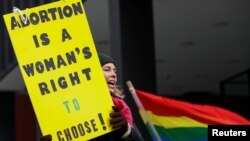 An anti-Trump demonstrator protests at an abortion rights rally in Chicago, Jan. 15, 2017.