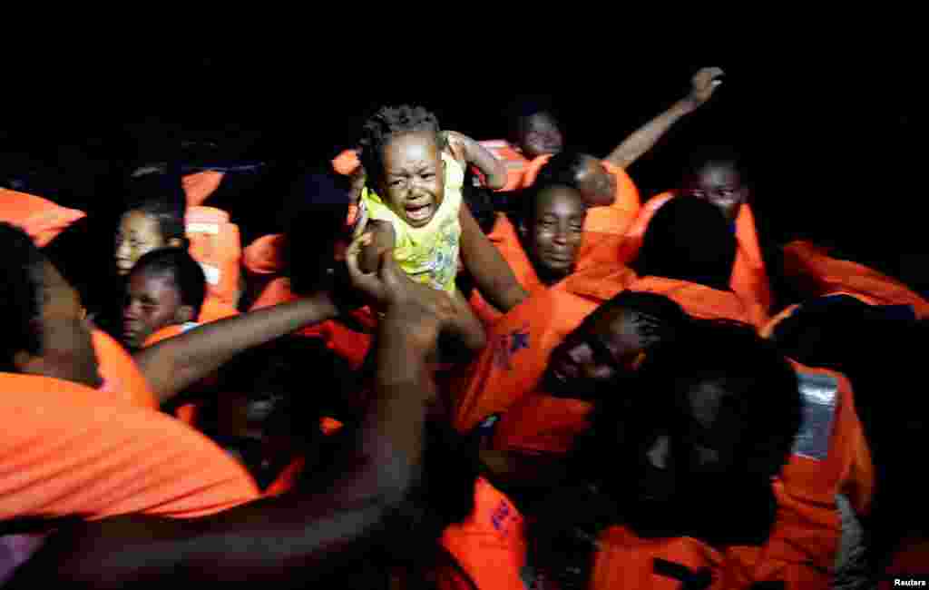 Migrants are seen during rescue operation in the Mediterranea Sea.