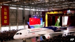 The first twin-engine 158-seater C919 passenger plane, seen in this Nov. 2, 2015 file photo, made by The Commercial Aircraft Corp. of China (COMAC) is pulled out of the company's hangar during a ceremony near the Pudong International Airport in Shanghai, China. After years of delays, China's first large homemade passenger jetliner will take to the air for its maiden flight in the first half of this year, state media reported Monday, Feb. 6, 2017. 