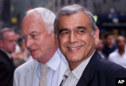 FILE - In this July 27, 1999, photo, film director James Ivory, left, and producer Ismail Merchant arrive for an auction of movie memorabilia at a hotel in New York.