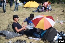 Many people here fled areas controlled by Islamic State militants, and some cover their heads to avoid being photographed.