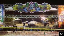 Police investigators inspect the stage area after an accidental explosion during a music concert at the Formosa Water Park in New Taipei City, Taiwan, June 28, 2015.