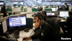 Saudi security guards monitor screens at the National Center for Security Operations in the holy city of Mecca, Saudi Arabia, Aug. 29, 2017. 