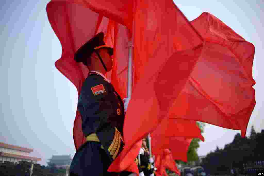 Chinese honor guards prepare for the arrival of Chinese Premier Li Keqiang and Algerian Prime Minister Abdelmalek Sellal during a welcome ceremony outside the Great Hall of the People in Beijing.