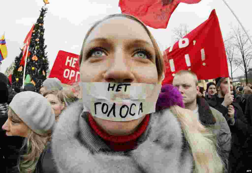 A protester stands during a rally in downtown St. Petersburg, Russia, Saturday, Dec. 10, 2011. The sign reads "No vote." More than 10,000 people have protested in St. Petersburg against Prime Minister Vladimir Putin and his party, which won the largest sh