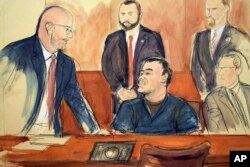 FILE - In this courtroom drawing, Joaquin "El Chapo" Guzman, seated at center, speaks to his attorney, Eduardo Balarezo, after a judge denied his request to speak directly to the court, Feb. 15, 2018, in New York.