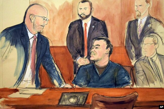 FILE - In this courtroom drawing, Joaquin "El Chapo" Guzman, seated at center, speaks to his attorney, Eduardo Balarezo, after a judge denied his request to speak directly to the court, Feb. 15, 2018, in New York.