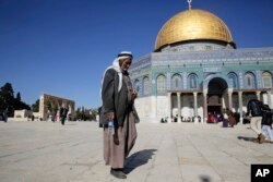 A Palestinian walks in front of the Dome of the Rock ahead of the prayers in Jerusalem, Dec. 8, 2017.