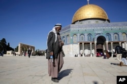 FILE - A Palestinian walks in front of the Dome of the Rock ahead of the prayers in Jerusalem, Dec. 8, 2017.