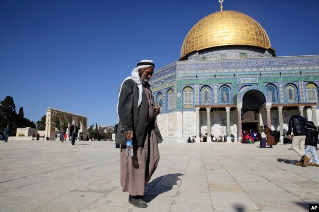 FILE - A Palestinian walks in front of the Dome of the Rock ahead of the prayers in Jerusalem, Dec. 8, 2017.