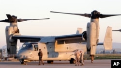 FILE - U.S. Marine officers work next to an MV-22 Osprey VTOL aircraft at the Sigonella airbase, Sicily, March 24, 2011. The Pentagon is looking for a new generation of such planes.