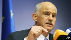 Greece's PM George Papandreou addresses a news conference at the end of an European Union leaders summit in Brussels, June 24, 2011