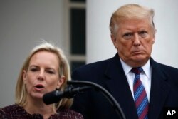 FILE - President Donald Trump listens as Homeland Security Secretary Kirstjen Nielsen speaks in the Rose Garden of the White House after a meeting with Congressional leaders on border security at the White House, Jan. 4, 2019.