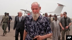 Released Dutch hostage Sjaak Rijke walks on the runway after arriving by airplane in Bamako, April 7, 2015. 
