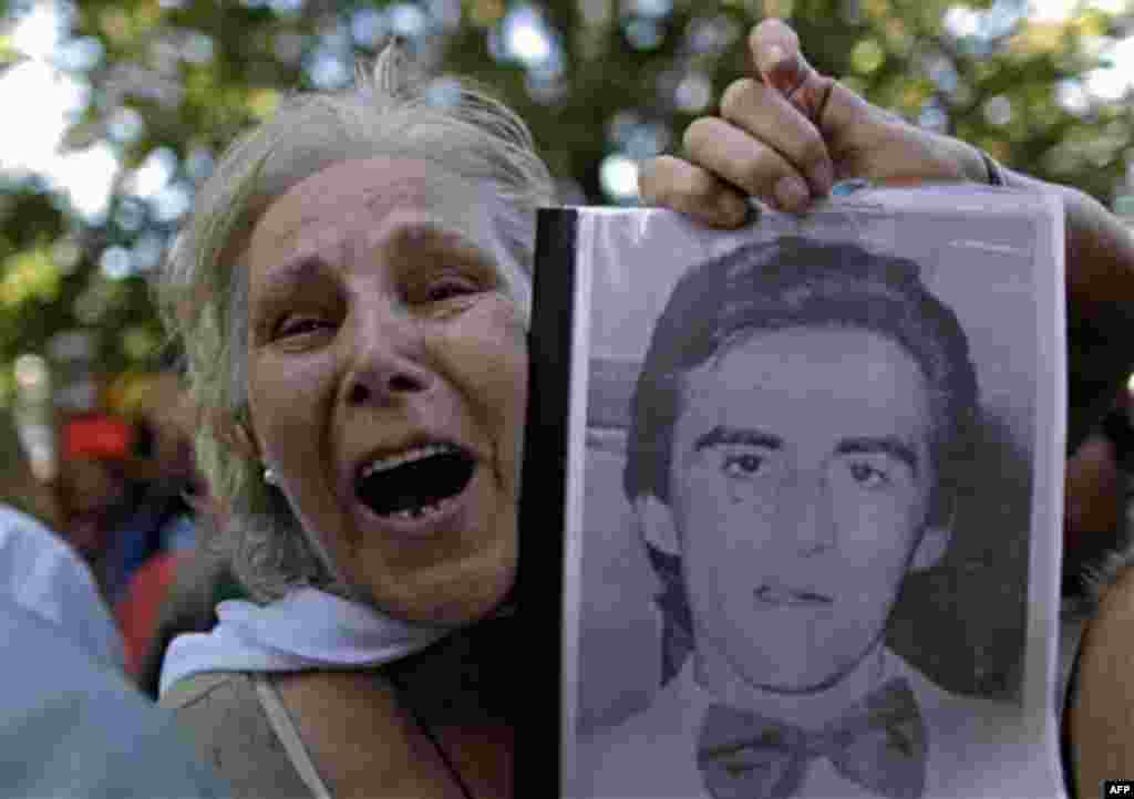 Pepa Pussek holds a picture of her son Juan Carlos Galvan, one of the victims killed during Argentina's dirty war, as she listens to the sentence for former dictator Jorge Videla in Cordoba, Argentina, Wednesday Dec. 22, 2010. Videla was sentenced to lif