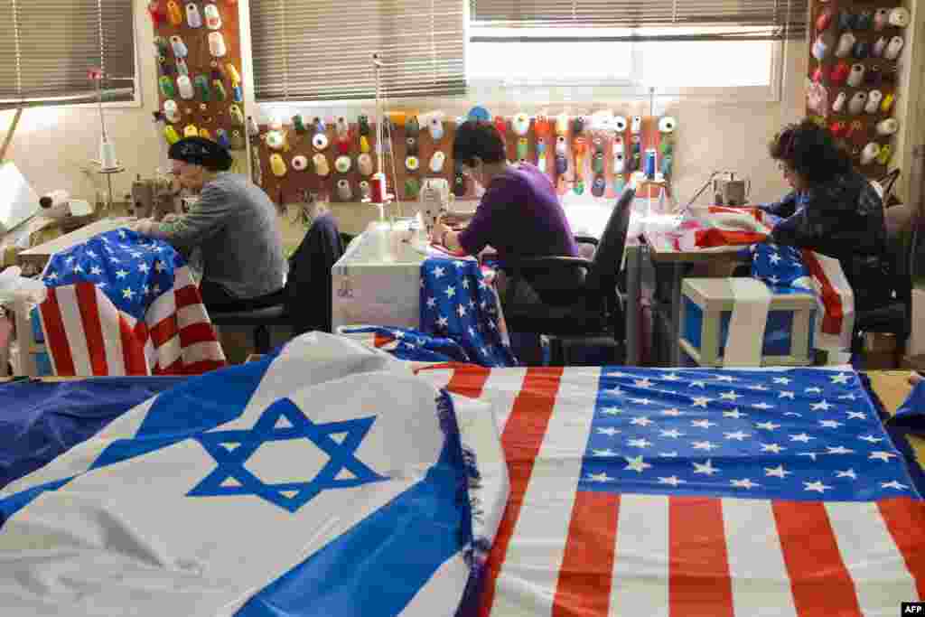 Israeli and U.S. flags are seen at a workshop in the town of Kfar Saba as employees sew flags in preparation for the upcoming visit of U.S. President Barack Obama. Obama's three-day visit to Israel and the Palestinian territories will begin on March 20.