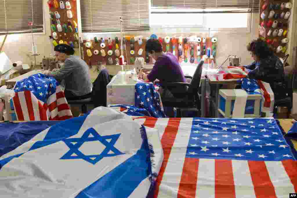 Israeli and U.S. flags are seen at a workshop in the town of Kfar Saba as employees sew flags in preparation for the upcoming visit of U.S. President Barack Obama. Obama&#39;s three-day visit to Israel and the Palestinian territories will begin on March 20.