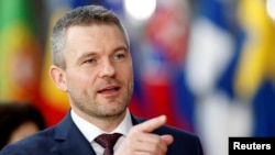 FILE - Slovak Prime Minister Peter Pellegrini gestures as he arrives at a European Union summit in Brussels, Belgium, March 22, 2018. 