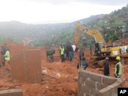 Rescue workers search for survivors following a mudslide in Regent, east of Freetown, Sierra Leone, Aug. 14 , 2017.