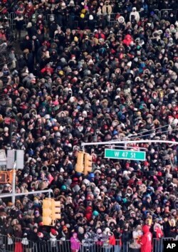 FILE - Revelers wait for midnight during the New Year celebrations in Times Square as seen from the Marriott Marquis in New York, Dec. 31, 2017.