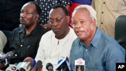 Opposition party presidential candidate Edward Lowassa, right, speaks to the media at a news conference in Dar es Salaam, Tanzania, Oct. 28, 2015.