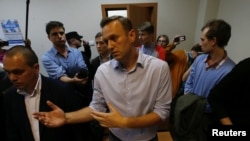 Russian opposition leader Alexei Navalny talks to journalists after he was sentenced by a court to 20 days in jail on charges of repeatedly violating laws governing the organisation of public meetings and rallies, during a hearing in Moscow, Russia, Oct. 2, 2017.