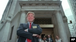 FILE - Developer Donald Trump poses for photos outside the New York Stock Exchange after the listing of his stock in New York, June 7, 1995. 