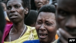 Women grieve during the burial of seven miners, victims of a collapsed mine, at the Ntunga public cemetery in Rwamagana, eastern Rwanda, Jan. 22, 2019. 