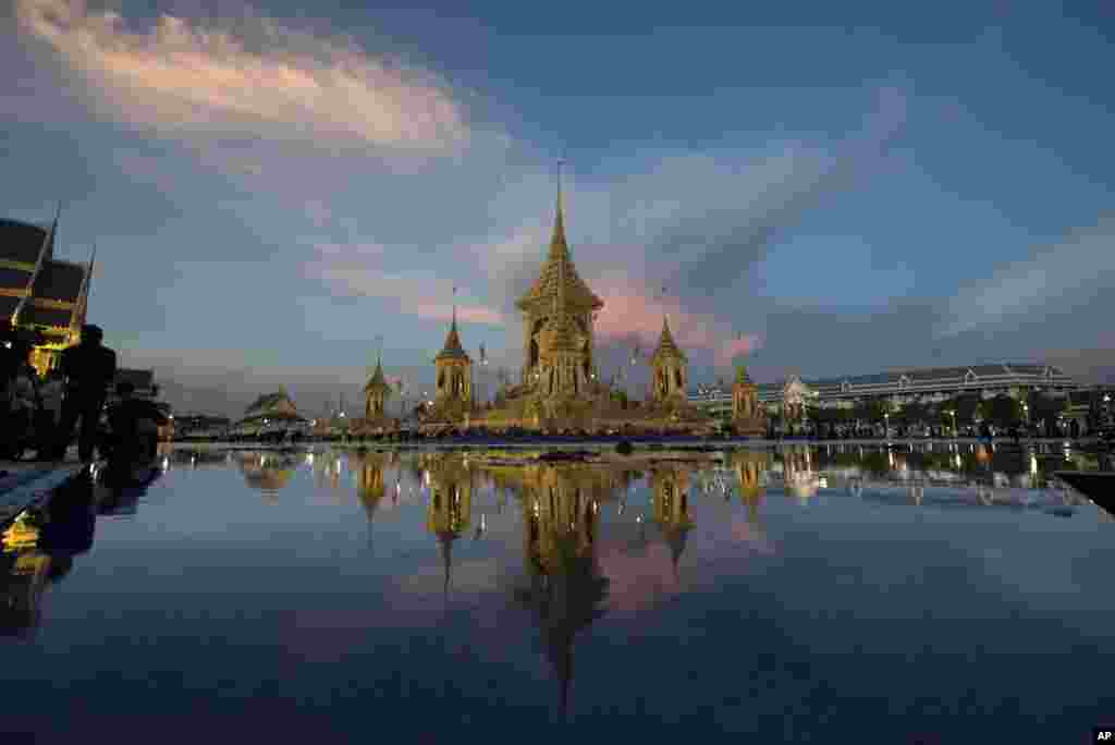 Light fades behind the completed royal crematorium and funeral complex for the late Thai King Bhumibol Adulyadej Bangkok, Thailand, Friday, Oct. 20, 2017. Thai artists and craftsmen have put the finishing touches on the elaborate crematorium complex ahead of the funeral of King Bhumibol Adulyadej. (AP Photo/Kittinun Rodsupan)