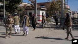 Taliban fighters secure the area after a roadside bomb went off in Kabul Afghanistan, Nov. 15, 2021.