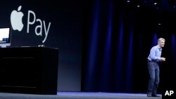 FILE - Craig Federighi, Apple senior vice president of Software Engineering, speaks about Apple Pay at the Apple Worldwide Developers Conference event in San Francisco, June 8, 2015.