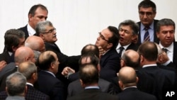 Turkish legislators from Prime Minister Recep Tayyip Erdogan's ruling party and the main opposition Republican People's Party brawl during a tense all-night debate over a controversial law on changes to a council that appoints and oversees judges and prosecutors, in Ankara, Feb. 15, 2014.