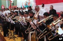 In this July 23, 2019 photo, prisoner Martin Reano performs a trombone solo during a musical collaboration with Peru's symphony orchestra at a prison courtyard in Callao, Peru. AP Photo/Martin Mejia)