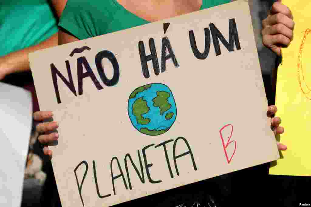 An attendee holds a sign which reads &quot;There is no planet B&quot; during the demonstration to demand more protection for the Amazon rainforest, in Rio de Janeiro, Brazi, Aug. 25, 2019.