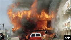A Korean-American shopping mall burns at Third Street and Vermont Avenue in Los Angeles on April 30, 1992, the second day of rioting in the city over a police beating case
