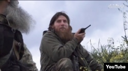 FILE - One of the most prominent foreign fighters in Syria is Chechen Muslim Shishani, who leads the Islamist Junud Ash Sham group. He’s shown at Jisr ash-Shugar in a YouTube video screengrab on April 21, 2015.