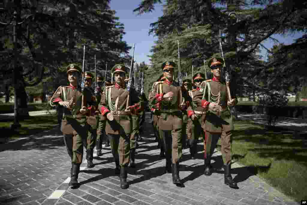 Guard of Honor march at the presidential palace during a visit by Britain's Prime Minister David Cameron in Kabul, Afghanistan, Oct. 3, 2014.