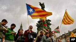 People wave pro-independence flags during a rally in support for the secession of the Catalonia region from Spain, in Vitoria, northern Spain, Sept. 9, 2017. 