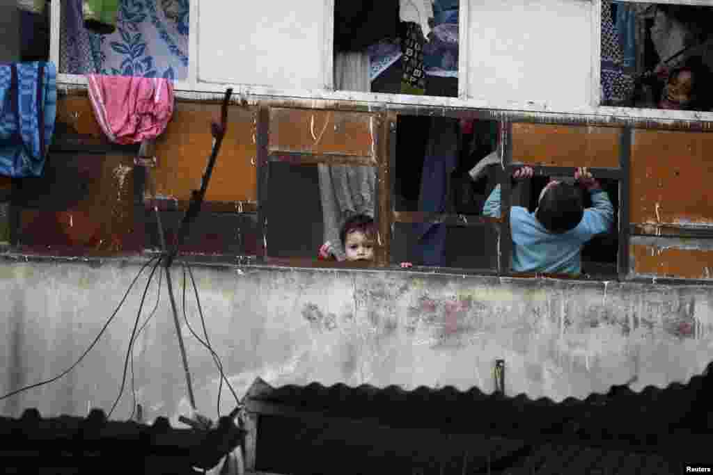 A child looks out of a window in Aleppo, Syria, Feb. 28, 2013.