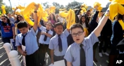 Students from St. Joseph Catholic School wave yellow scarfs during a rally in support of school choice on Jan. 24, 2017, in Austin, Texas.