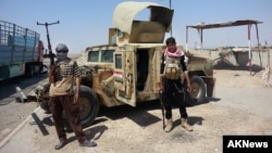 Militantes del grupo Estado islámico junto a un Humvee capturado al ejército iraquí.